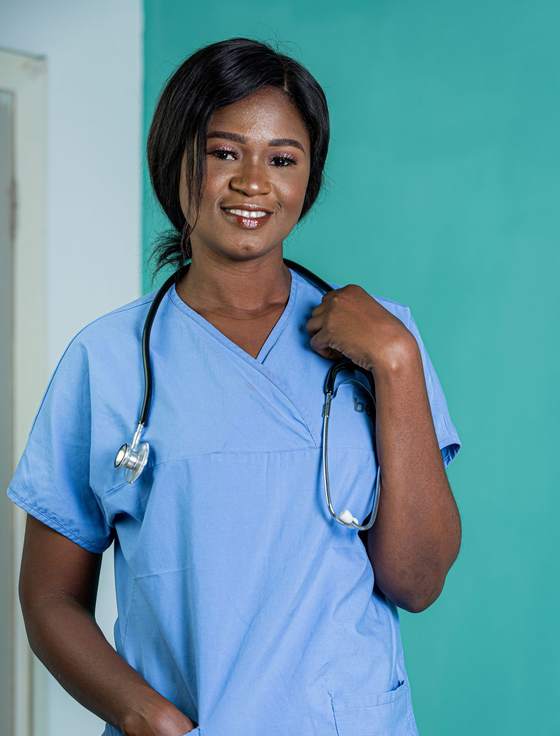 A smiling nurse in blue scrubs with a stethoscope