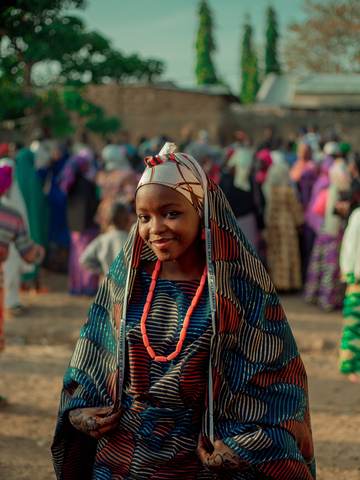 A young woman smiling in traditional dress in Kaduna